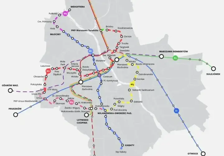 Mapa pokazuje stacje metra M2 i inne linie kolejowe w Warszawie, z zaznaczonymi węzłami przesiadkowymi i nazwami przystanków.