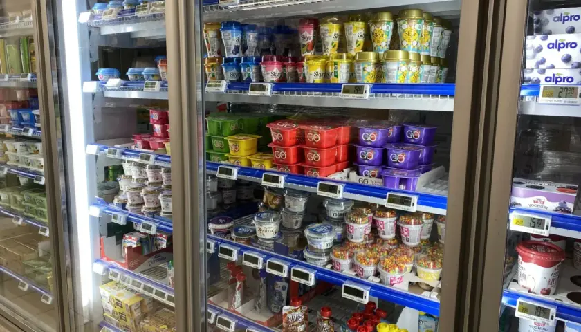 W chłodziarce sklepowej widać jogurty i inne produkty mleczne. Nie ma tu informacji, ile kosztuje chleb w Norwegii.