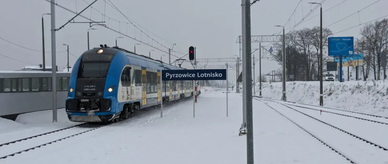 Zimowy pociąg na stacji Pyrzowice Lotnisko, idealny do podróży z Kielc do Katowic.